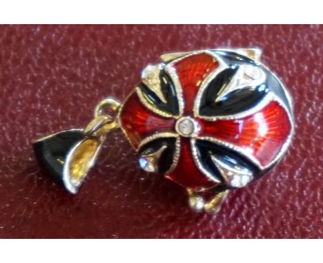 A modern Faberge-style enamel and rhinestone decorated pendant/locket in the form of an easter egg.