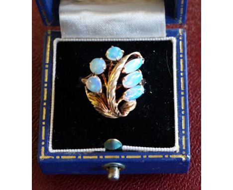 A 14k stamped yellow metal and opal fancy ring.