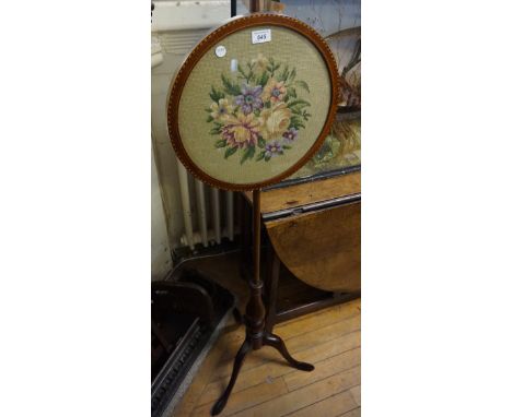 A tapestry inset fire screen.