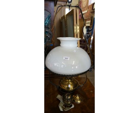 A mid 20th Century cast metal hanging paraffin lamp with milk glass shade (converted to electricity).