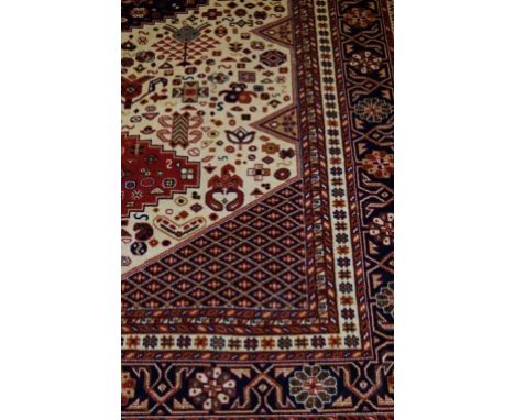 A Caucasian carpet on a mainly beige ground
The central panel with three multi coloured diamond medallions, flanked by matchi