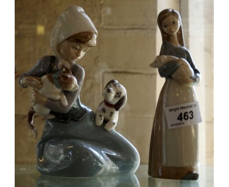 A Lladro figure of a girl holding a cat and a further Lladro figure of a girl holding a pig.