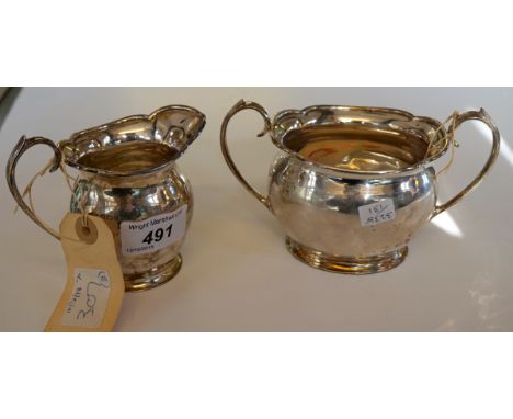 A Sheffield hallmarked silver cream jug together with a Sheffield hallmarked silver twin handled sugar bowl, total weight 9.3