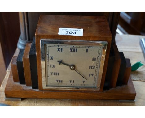 An Art Deco walnut decorated mantel clock.