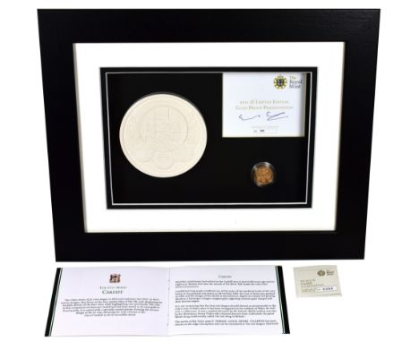 g Elizabeth II (1952-), gold Proof One Pound Coin, 2011, in presentation picture frame with plaster cast of the Cardiff rever