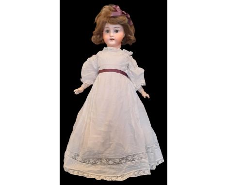 Early 20th century bisque head doll by E Heubach with closing brown eyes, open mouth with teeth and jointed composition body,
