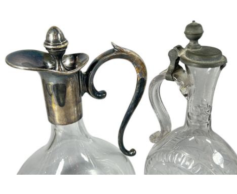 An early 20th century claret jug with a silver plated collar and handle together with another engraved decanter with a hinged