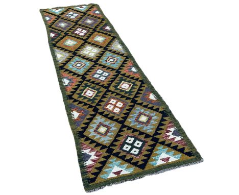 A Maimana kilim runner with  double rows of stepped diamond on a dark ground 292cm x 83cm approximately 