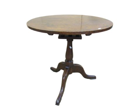 A Georgian oak tripod table raised on a vase shaped pillar with bird cage action, 76cm diameter