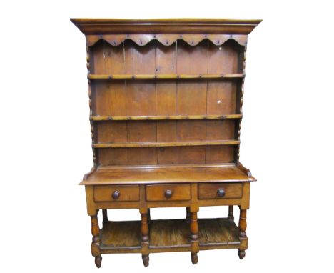 A 19th century oak Cottage pot board dresser, the base enclosed by three frieze drawers, raised on eight turned supports with