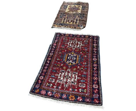 An Anatolian carpet, with a central hooked medallion on a red ground 140cm x 100cm approximately together with a Middle Easte