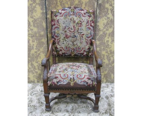 19th century French open armchair with floral tapestry upholstery within a show wood frame with carved detail 