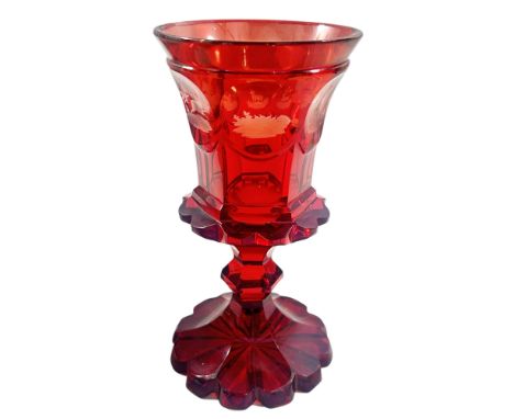 A heavy cut-glass Bohemian red glass goblet with deer hunting panels, 19cm