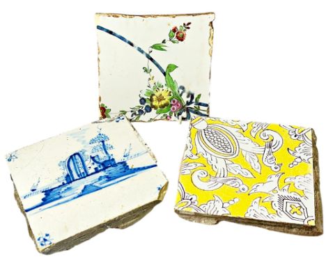 An 18th century delft tile with landscape detail, further tin glazed example with floral detail and one other