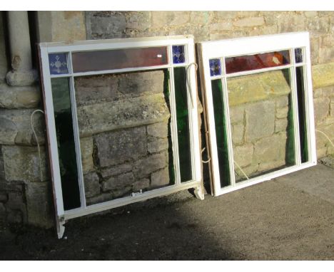 Two reclaimed painted pine framed sash windows enclosing coloured glass panels (af), 96 cm high x 90 cm approximately