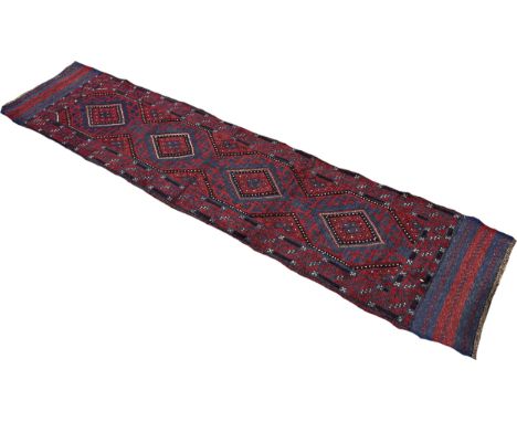 A Meshwani runner with a central row of red and blue diamonds 247cm x 62cm approximately 