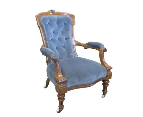 A Victorian walnut drawing room chair with upholstered seat and buttoned back within a shaped, carved and moulded frame