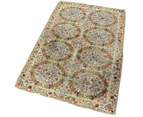 A Kashmiri chain stitched rug with eight oval floral panels, 140cm x 95cm approximately