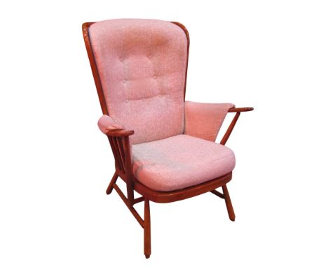 An Ercol Windsor style hoop and stickback elbow chair with loose upholstered sprig patterned cushions 