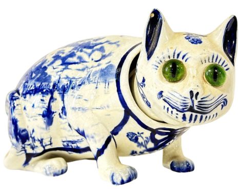An unusual antique Faience style ceramic cat figure decorated with Delft design blue and white transfer print, head suspended