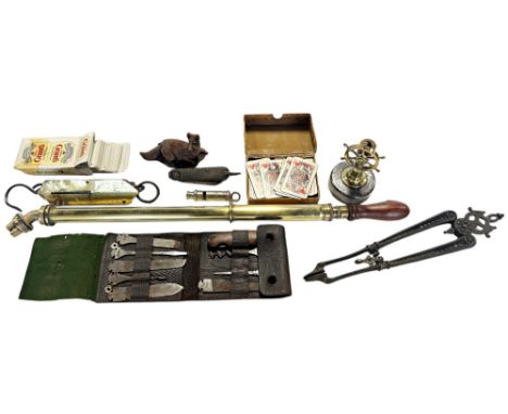 A miscellaneous collection of items including a brass bicycle pump, a vintage penknife, a miniature brass ship’s wheel, weigh