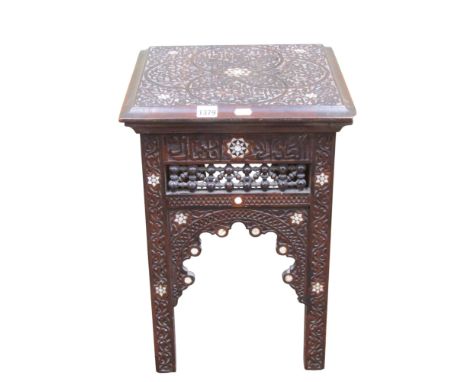 An Islamic occasional table the framework with profuse scrolling and calligraphy detail, mother of pearl and other decoration