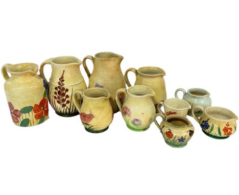 A group of Radford pottery, decorated throughout with floral motifs, to include jugs, vases etc, (23)