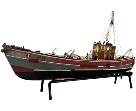 A model of a French fishing boat Angele Rouge Concarneau, the deck littered with nets, lobster pots, floats etc raised on a t