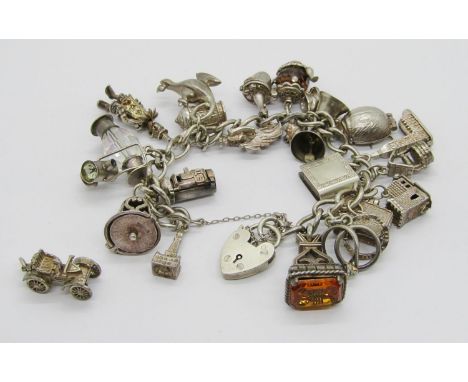 Silver curb link charm bracelet with heart padlock clasp, hung with twenty-one novelty charms to include a beetle charm which