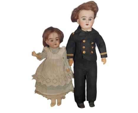 Two early 20th century small German bisque head dolls comprising a doll with 5 piece wooden body and fixed brown eyes wearing