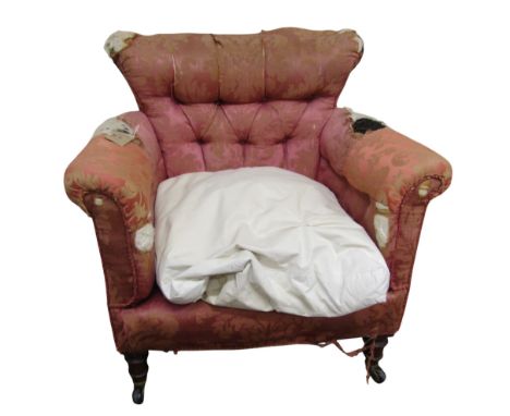 A Victorian upholstered armchair in the manner of Howard &amp; Sons and of 'Woodstock' design, with a buttoned back on turned