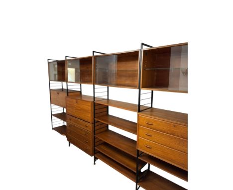 A Staples Ladderax sectional lounge wall unit comprising five metal ladder uprights, nine teak modular units, twenty-one shel