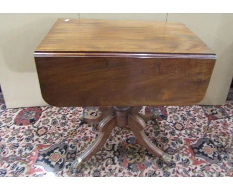 An unusually small Georgian mahogany Pembroke table enclosing two frieze drawers, raised on a turned pillar and quadruped, wi