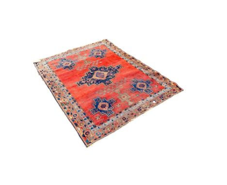 An Afshar rug with a central extended medallion on a brick red ground 190cm x 142cm approximately 