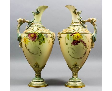 A pair of late 19th Century Royal Worcester bone china "Blush Ivory" ewers, the body and handle moulded in the "Renaissance" 