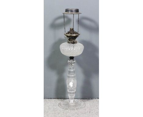 A late Victorian/early 20th Century heavy cut-glass oil lamp with oval panel and hobnail cut reservoir, the slightly bulbous 