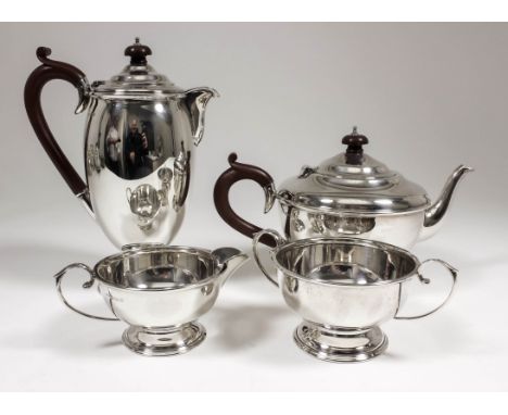 A George V silver circular four piece tea service with moulded rims and girdles, C-scroll handles and circular footrims, comp