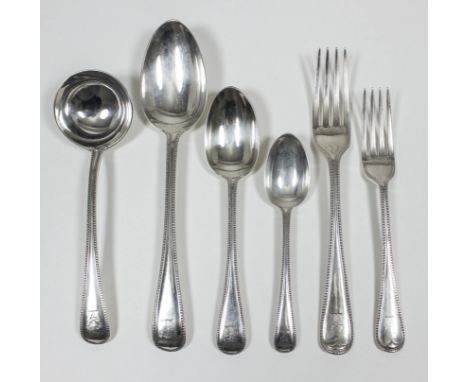 A Victorian silver part table service with bead mounts by Chawner & Co, London 1875, comprising - eleven table spoons, twelve