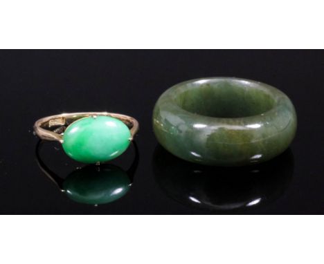 A Chinese gold coloured metal mounted jade set ring, the oval cabochon cut stone approximately 3ct (in a band bearing Chinese