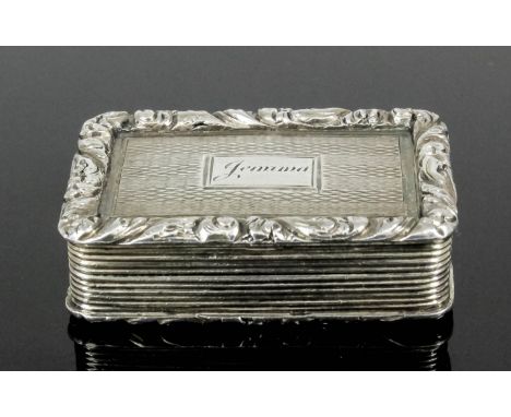 A George IV silver gilt rectangular vinaigrette, the lid and base with cast leaf scroll mounts and engine turned centre panel