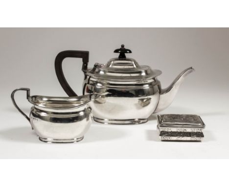 A George V silver rectangular teapot with ebonised finial and handle, 4.75ins high, and matching milk jug, by Aitken Brothers