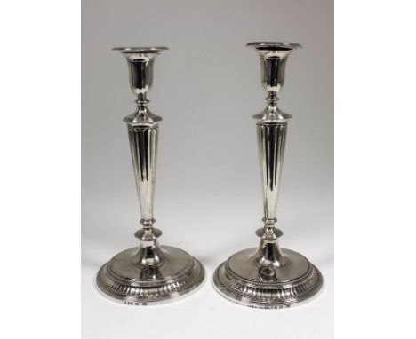 A good pair of George III cast silver pillar candlesticks and pair of matching two light candelabra branches, the whole of Ne