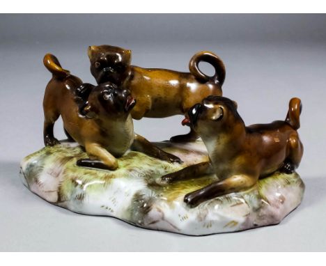 A Meissen porcelain model of three pug dogs playing, on naturalistically modelled base, 6.25ins long x 3.25ins high (blue cro
