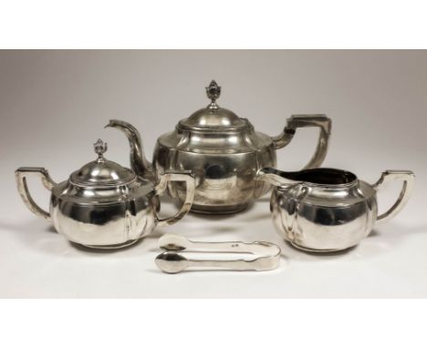 A Chinese silvery metal oval four piece tea service with panelled bodies, leaf pattern finials and angular handles, comprisin