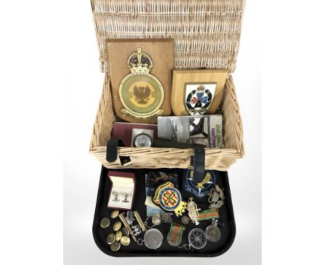 A group of medals, buttons, compass, various cloth insignia, military torch, two regimental wooden plaques, military ephemera