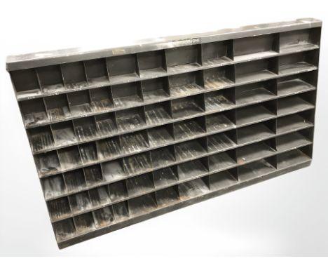 A vintage enameled metal corner stone pigeon hole shelf, 124 cm x 24 cm x 68 cm.