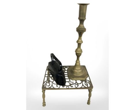 A Victorian pierced brass footman, width 33 cm, a large candlestick and an iron.