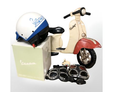 A tin scooter sign, Vespa helmet, several pairs of goggles. (1 box)