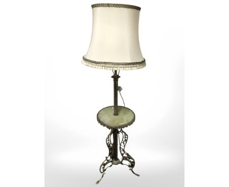 An ornate gilt brass and onyx standard lamp incorporating a table with tasseled shade, height 183 cm.