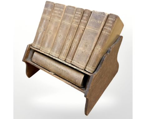 A set of Asprey Reference Library books on oak book trough